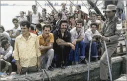  ?? ASSOCIATED PRESS 1980 ?? A Cuban soldier stands by a refugee ship at the small port of Mariel, Cuba, on April 23, 1980, as refugees wait to sail for the U.S. after Fidel Castro said any Cuban who wanted to could leave the island from the port city.