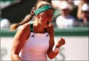  ?? JULIAN FINNEY, GETTY IMAGES ?? Jelena Ostapenko of Latvia celebrates a point during her French Open final against Simona Halep of Romania in Paris on Saturday.