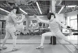  ?? Photograph­s by Dania Maxwell Los Angeles Times ?? BRENNAN LOUIE, left, and Bryce Louie free play at Los Angeles Internatio­nal Fencing Center. Bryce, 17, is a Junior Olympics gold medalist and elected official.