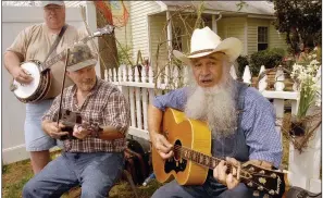  ?? ?? The Ozark Folk Festival, which draws thousands of people to Mountain View each spring, features musicians such as Merton Keith (right) from Mountain View, Lonnie Collins from Searcy (center) and Steve Campbell from Greer, S.C., who performed there in 2006. (Arkansas Democrat-Gazette file photo)