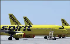  ?? CHRIS O’MEARA — THE ASSOCIATED PRESS FILE ?? A line of Spirit Airlines jets sit on the tarmac at the Orlando Internatio­nal Airport in Orlando, Fla. Shareholde­rs of Spirit Airlines will vote today on a proposed merger with Frontier Airlines, and the outcome could affect fares for millions of air travelers who depend on the budget airlines.