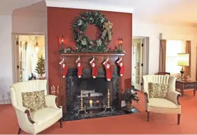  ?? ANGELA PETERSON, MILWAUKEE JOURNAL SENTINEL ?? The fireplace in the living room is hung with stockings bearing each of the grown children's names.