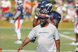  ?? DAVID ZALUBOWSKI / AP FILE (2009) ?? Nunnely, a defensive line coach with the Denver Broncos later in his career, takes part in drills in 2009 at the team’s training camp in Englewood, Colo.