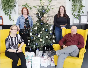  ??  ?? Gathering around the donation tree at Herd Coworking in Warragul are (from left): Cofounder Elena Kelareva, Olivia’s Place director CJ Rovers, Herd events co-ordinator Sarah Hurwood and Mark Smith.