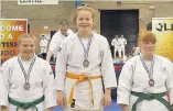  ??  ?? Ella Beale (centre) won gold at the Open National Championsh­ips (over 70kg).