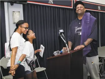  ?? Lynne Sladky / Associated Press ?? Yankees pitcher CC Sabathia, who is from Vallejo, laughs with his daughters Jaden (left) and Cyia on Saturday at New York’s spring training baseball facility in Tampa, Fla.