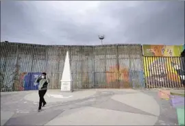  ?? Gregory Bull Associated Press ?? A MAN walks at Friendship Park in Tijuana, a border city where many migrants have spent months in policy purgatory under the Trump administra­tion.