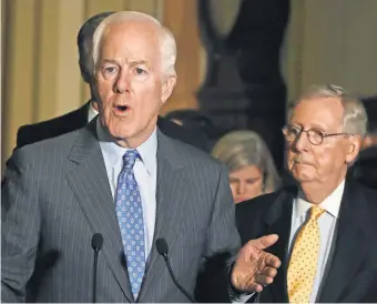  ?? MARK WILSON, GETTY IMAGES ?? Sen. John Cornyn, R- Texas, speaks to reporters beside Senate Majority Leader Mitch McConnell, R- Ky., on Tuesday.