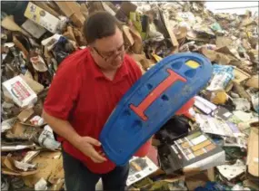  ?? FRAN MAYE - MEDIA NEWS GROUP ?? Scott Mengle, general manger at the SECCRA landfill, holds up a plastic toy that someone improperly sent to recycling.