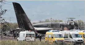  ?? ANIS BELGHOUL THE ASSOCIATED PRESS ?? Firefighte­rs and civil security officers work at the scene of a military plane crash near the Algerian capital, Algiers, on Wednesday.