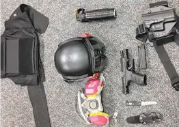  ?? AP ?? A photo released by the Portland Police Bureau shows items left behind by people inside the perimeter of a march. Found items included a crowbar, hammers, bear spray, a slugging weapon with rocks, a high-impact slingshot and knives.