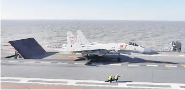  ??  ?? (FILES) This file photo shows a Chinese J-15 fighter jet preparing to take off from the deck of the Liaoning aircraft carrier during military drills in the Bohai Sea, off China’s northeast coast. China continues to arm itself faster than other...