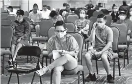  ?? SUE OGROCKI/AP ?? More than 1.3 million people applied for jobless benefits last week. Above, people wait at the Oklahoma Employment Security Commission about claims Thursday in Midwest City.