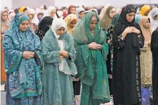  ?? DAMIAN DOVARGANES/THE ASSOCIATED PRESS ?? American Muslim women pray to mark the end of the holy month of Ramadan on Wednesday at Petree Hall in Los Angeles. Some Muslim and Arab American leaders have grown frustrated with outreach from President Joe Biden’s White House.