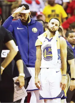  ??  ?? Stephen Curry of the Golden State Warriors, right, reacts after they were defeated 127105 by the Houston Rockets in Game 2 of the NBA Western Conference Finals yesterday at the Toyota Center in Houston. (AFP)