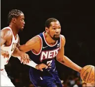  ?? Sarah Stier / Getty Images ?? The Nets’ Kevin Durant dribbles as the Cavaliers’ Caris LeVert defends during the first half at Barclays Center on Friday in Brooklyn.