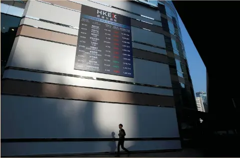  ?? (Bobby Yip/Reuters) ?? A PANEL displays a list of top active securities outside the Hong Kong Stock Exchange earlier this year. At the heart of the three-way tussle lies an estimated $500 billion worth of Chinese tech firms expected to seek listings in the coming years, representi­ng the biggest potential pool of IPO fees in the world outside the US tech sector.