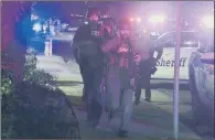  ?? PICTURE: ?? ARMED RESPONSE: Police officers and FBI agents run to the scene of the shooting at the Borderline bar in Thousand Oaks, California.