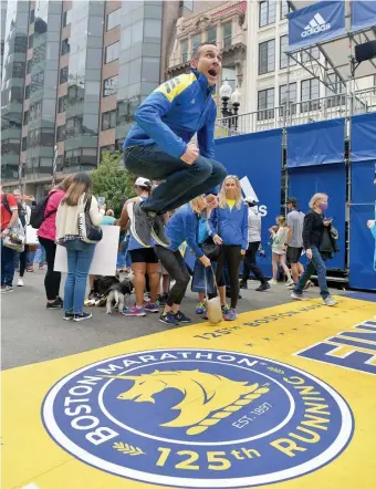  ?? ?? HYPED HOPS: Mark Coalmer, of Cypress, Texas, says he’s known for his leaping at the end of the race so he shows it to the group he was with. He will be running in his third Boston Marathon today.