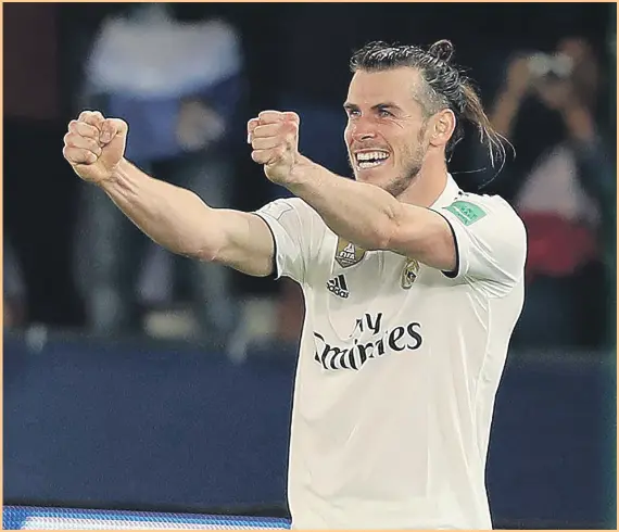  ?? Chris Whiteoak / The National ?? Gareth Bale celebrates after completing his hat-trick for Real Madrid against Kashima Antlers in Abu Dhabi last night, as his team ran out 3-1 winners. The Spanish side will now take on Al Ain in the Fifa World Club Cup final on Saturday. Full report on pages 32-33