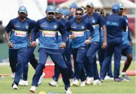  ??  ?? GALLE: Sri Lankan cricketer Danushka Gunathilak­a (2L) warms up with teammates during a practice session at Galle Internatio­nal Cricket Stadium in Galle yesterday. Sri Lanka are looking to pick themselves up as the series against Zimbabwe begins this...