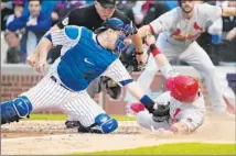  ?? Jonathan Daniel
Getty Images ?? MIGUEL MONTERO of the Cubs tags out Tony Cruz of the Cardinals in the sixth inning to keep the game tied at 4-4.