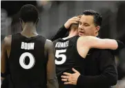  ?? CHARLIE RIEDEL / AP ?? Xavier head coach Sean Miller greets guard Adam Kunkel and guard Souley Boum after their loss against Texas in a Sweet 16 game Friday in Kansas City.