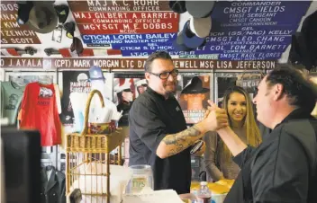  ?? Photos by James Tensuan / Special to The Chronicle ?? Rio Grill chef Cy Yontz (left) greets Bennett Compagno at Compagno’s Market and Deli in Monterey.