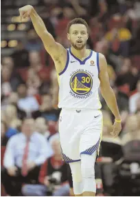 ?? AP PHOTO ?? COUNT IT: Stephen Curry gestures after hitting a 3-pointer during the Warriors’ 124-114 victory against the Rockets last night in Houston.