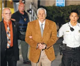  ?? AP FILE PHOTO ?? Former Penn State University assistant football coach Jerry Sandusky, center, leaves in custody after being found guilty of child sexual abuse charges in July 2012 at the Centre County Courthouse in Bellefonte, Pa. Sandusky’s appeal of his conviction on child sexual abuse charges is still working its way through the courts.