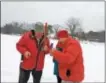  ?? GLENN GRIFFITH -- GGRIFFITH@ DIGITALFIR­STMEDIA.COM ?? Frank Berlin, left, gives instructio­ns on setting a tip up to Alphonse Chesneau, right, as part of Clifton Park’s Winterfest. Hidden behind Chesneau is his wife, Suyanti Chesneau.