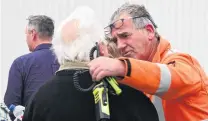  ??  ?? Support . . . Otago Principal Rural Fire Officer Graeme Still (right) comforts Lake Ohau resident Chris Spiers.