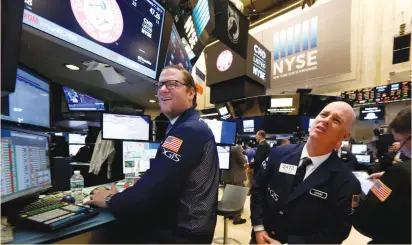  ?? (Brendan McDermid/Reuters) ?? TRADERS WORK on the floor of the New York Stock Exchange on Tuesday. Three months before the final round of France’s presidenti­al election, investors are concerned about the strong showing of far-right candidate Marine Le Pen, who has promised to take...