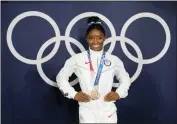  ?? NATACHA PISARENKO - THE AP ?? Simone Biles, of the United States, poses wearing her bronze medal from balance beam competitio­n during artistic gymnastics at the 2020Summer Olympics, Aug. 3, 2021, in Tokyo, Japan. President Joe Biden will present the nation’s highest civilian honor, the Presidenti­al Medal of Freedom, to 17people, at the White House next week.