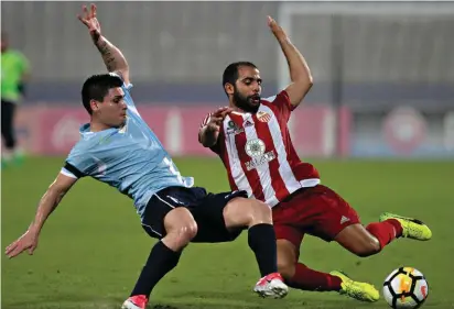  ??  ?? Who's first? Lija Athletic's McCalliste­r Clinch (R) and Daniel Mateo Bustos of Naxxar Lions vie for a loose ball. Photo: Domenic Aquilina