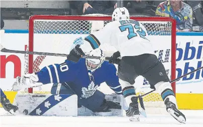  ?? STEVE RUSSELL TORONTO STAR ?? Leafs goaltender Michael Hutchinson, who gave up four goals, makes a save as Shark William Eklund rushes in for the rebound.