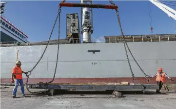  ?? Photos by Steve Gonzales / Staff photograph­er ?? Longshore workers Jesus Carcini, left, and Liliana Garcia unload Mexican steel from a ship at the Port of Houston, which has seen imports of steel and iron and products made from them decline from a year ago.