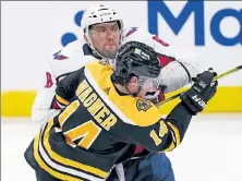  ?? AP ?? Capitals left wing Alex Ovechkin checks Bruins right wing Chris Wagner during the second period Wednesday.