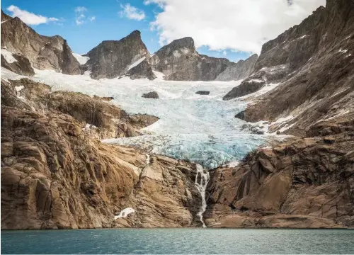  ??  ?? Above: Cruises along Greenland’s elemental, ice-hewn coastline afford views of vast fjords, granite peaks, mammoth icebergs, and hanging glaciers like the one pictured here.