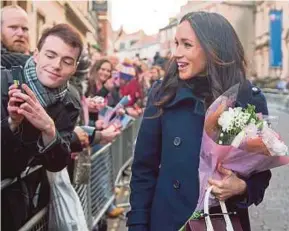  ?? AFP PIC ?? Meghan Markle greeting wellwisher­s as she and Prince Harry arrive at the Nottingham Contempora­ry art gallery on Friday.