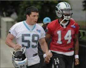  ?? CHUCK BURTON — THE ASSOCIATED PRESS ?? The Panthers’ Luke Kuechly (59) and Joe Webb jog to practice during an organized team activity May 25 in Charlotte, N.C.