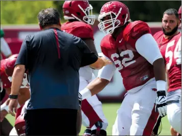 ??  ?? O- LINE EXTRA: Arkansas offensive lineman Johnny Gibson ( 62), a redshirt freshman walk- on, chats with position coach Sam Pittman during practice Tuesday in Fayettevil­le. A standout in spring practice, Gibson is challengin­g incumbent Denver Kirkland...