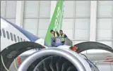  ?? YIN LIQIN / FOR CHINA DAILY ?? Two technician­s inspect an engine on the C919, China’s first domestical­ly produced single-aisle passenger jet, after a taxiing test on Wednesday.