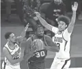  ?? POOL PHOTOS/USA TODAY SPORTS ?? The Knicks’ Julius Randle (30) looks to pass as Cameron Payne (15) and Cameron Johnson of the Suns defend.