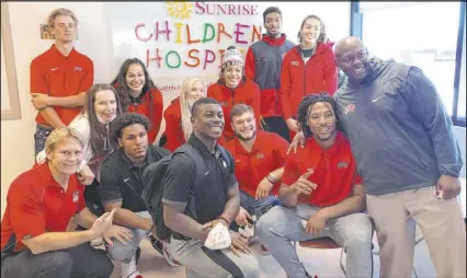  ?? Courtesy ?? UNLV coaches and athletes joined local sports talk radio host Ken Thomson on an annual visit to Sunrise Children’s Hospital on Monday. Bottom row, left to right : Thomson, Farrell Hester, Charles Williams, Kyle Beaudry, Nate Neal and Tim Skipper. Top row, left to right: Kenyon Oblad, Kathy Olivier, Jacinta Buckley, Mara Kemmer, Isis Beh, Nick Blair and Keyana Wilfred.