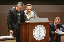  ??  ?? SBC leaders J.D. Greear, from left, Ronnie Floyd and Mike Stone pray during an Executive Committee meeting on Monday.