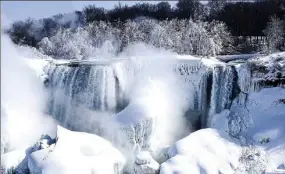  ?? AARON VINCENT ELKAIM / AGENCE FRANCE-PRESSE ?? Much of the United States side of Niagara Falls is frozen after a prolonged period of extreme cold. Many areas of the US and Canada are experienci­ng unusually cold weather, with record-low temperatur­es and windchill factors making it feel well below...