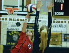  ?? RICK PECK/SPECIAL TO MCDONALD COUNTY PRESS ?? McDonald County’s Nicole Salas spikes over Neosho’s Brianna Keho during the Lady Mustangs 15-25, 25-13, 25-12 loss on Sept. 17 at Neosho High School.