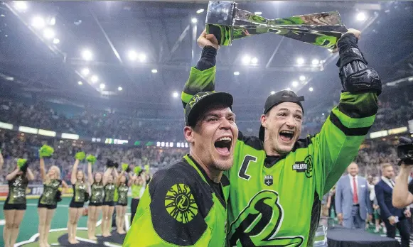  ?? LIAM RICHARDS/THE CANADIAN PRESS ?? The Rush’s Jeff Shattler and Chris Corbeil celebrate with the NLL Cup after defeating the Rochester Knighthawk­s Saturday night at Sasktel Centre.