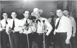  ?? Submitted photo ?? Bob Wills, center left, Gene Autry and Tommy Duncan perform on KCMC Radio in the early 1940s at the Grim Hotel Ballroom in downtown Texarkana, Texas.